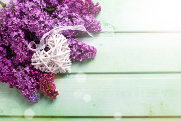 Background  with fresh lilac flowers and heart