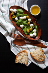 fresh light healthy summer salad with spinach, green and black o