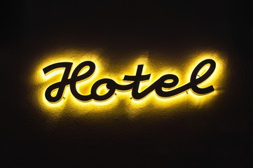 Illuminated hotel sign on the building