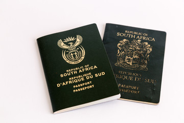 Old and new South African passports on white background