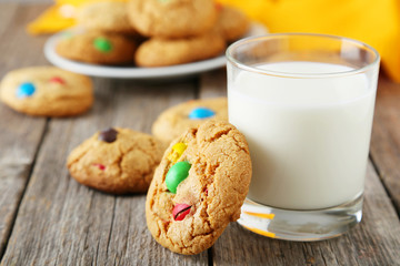 Cookies with colorful candy on grey wooden background