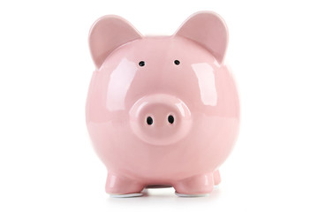 Pink piggy bank with glasses on white wooden background