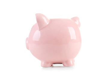 Pink piggy bank with glasses on white wooden background