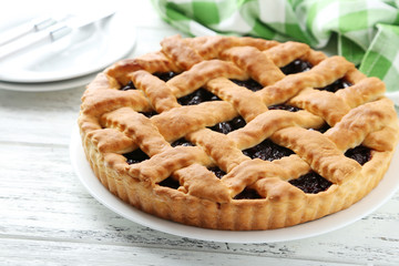 Homemade pie on white wooden background