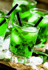 Green cocktail with mint, ice and soda, selective focus