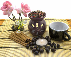 Fototapeta na wymiar Tea ceremony by candlelight with cinnamon, roses, cup, pepper mix isolated on white