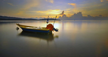 boat on the beach during sunrise