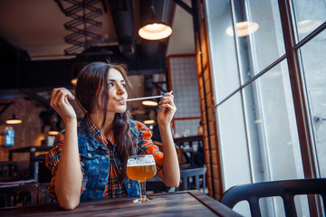 The girl in the cafe with a glass of beer.Art processing and ret