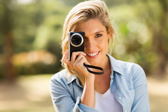 young woman taking pictures outdoors