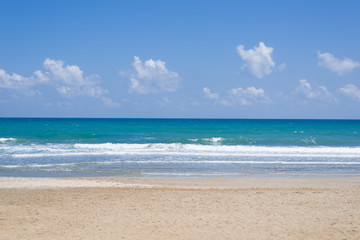 Fototapeta na wymiar Empty, sunny beach with blue sky