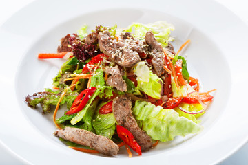 Restaurant food -  meat salad with roasted beef and vegetables