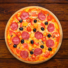 Delicious pizza with salami, mushrooms and olives