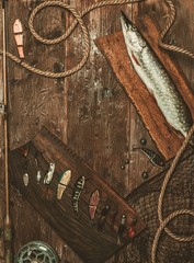 Fototapeta premium Fishing tools and fresh pike on a wooden table