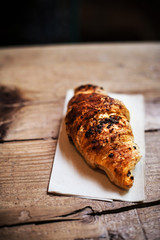 Fresh and tasty croissant on wooden table.