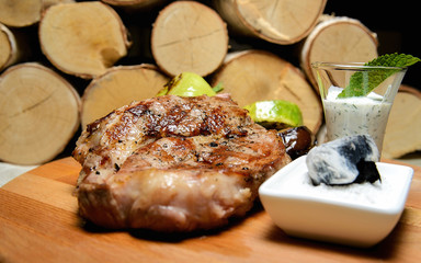 grilled meat lying on a wooden board
