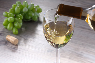 Pouring white wine into glass - 85062573