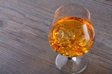 Glass of whiskey with ice cubes