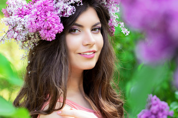 Portrait of a beautiful girl in pink with flowers