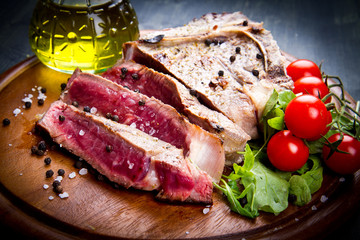 grilled sliced meat fillet on wooden background