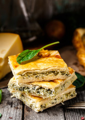 Homemade pie stuffed with cheese and spinach