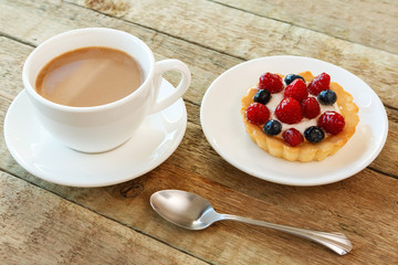 Cake with berries and cup of coffee