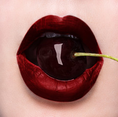 Sexy bite! A closeupcherry in her mouth.