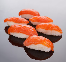 Sushi with red salmon on a black background