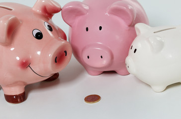 Three piggybanks on table