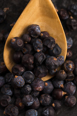 Juniper berries on a wooden background