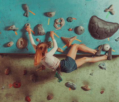 Little girl training in climbing gym