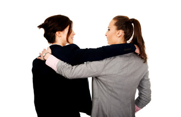 Two women embracing each other.