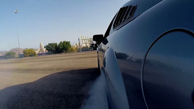 Powerful Muscle Car Spinning Into Circles, Making Doughnut And Burning Tyres - View From The Side Of A Car