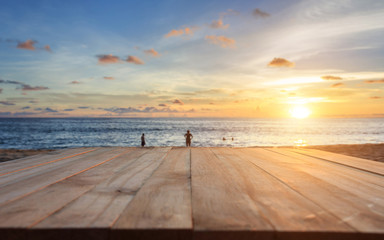 Fototapeta na wymiar Top of old wooden table at sunset beach in Thailand