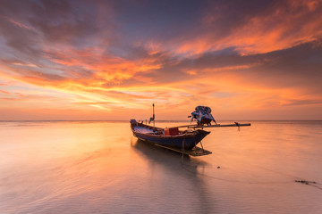 Traditional thai boats at the sea with beautiful sunset
