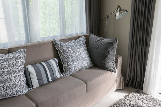 Sturdy brown tweed sofa with grey patterned pillows