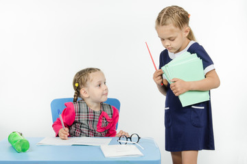 Teacher seeks pupil notebook pile of notebooks