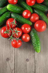 Tomatoes and cucumbers on wood