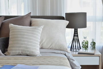 stylish bedroom interior design with brown patterned pillows on