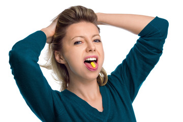 Beautiful woman with pill on her tongue.