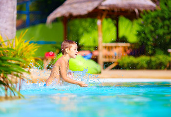 excited happy kid boy having fun in pool, summer vacation © Olesia Bilkei