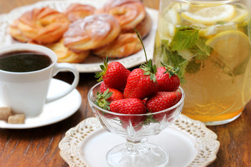 Breakfast with coffee, croissant, strawberry