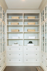 Fototapeta na wymiar large white walk-in closet with shelves at home