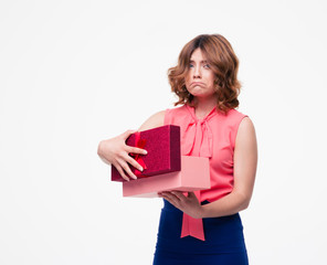 Sad casual woman opening gift box