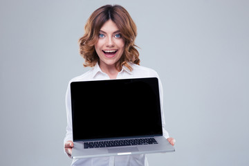 Happy businesswoman showing laptop screen