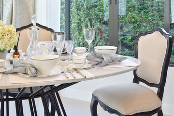 dining table and comfortable chairs in modern home with elegant