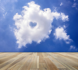 Empty wooden table with cloud and blue sky backgrounds. Blank space for put the produce or copy text