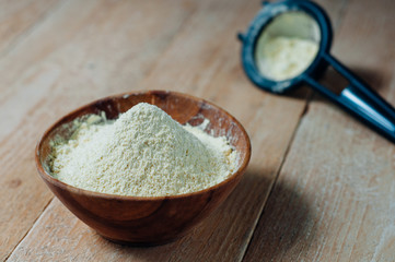Chickpea flour in old wooden bowl