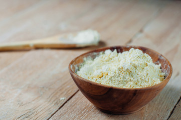 Chickpea flour in old wooden bowl