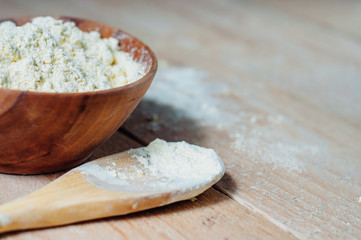 Chickpea flour in old wooden bowl