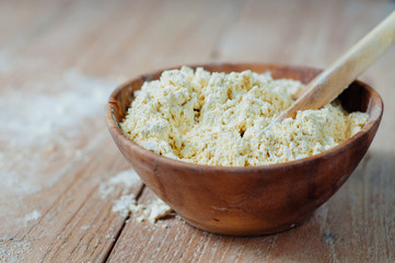 Chickpea flour in old wooden bowl